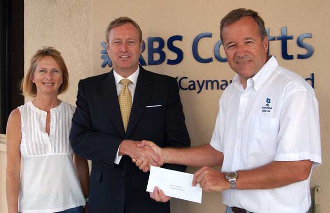 Jane Moon with David Foster, Head of Private Banking, RBS Coutts Cayman, presenting his firm’s sponsorship cheque to Andrew Moon, CISC Commodore. © Byte Class http://bytechamps.org/